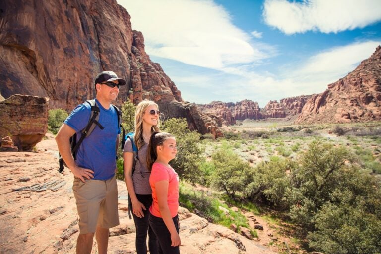 family looking out at a beautiful scenic view in a red rock canyon in the Southwest United States