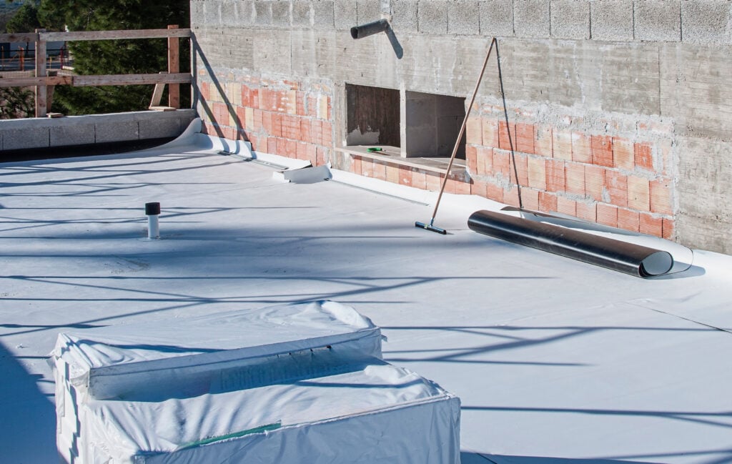 Worker on application Synthetic waterproofing PVC-P and TPO / FPO