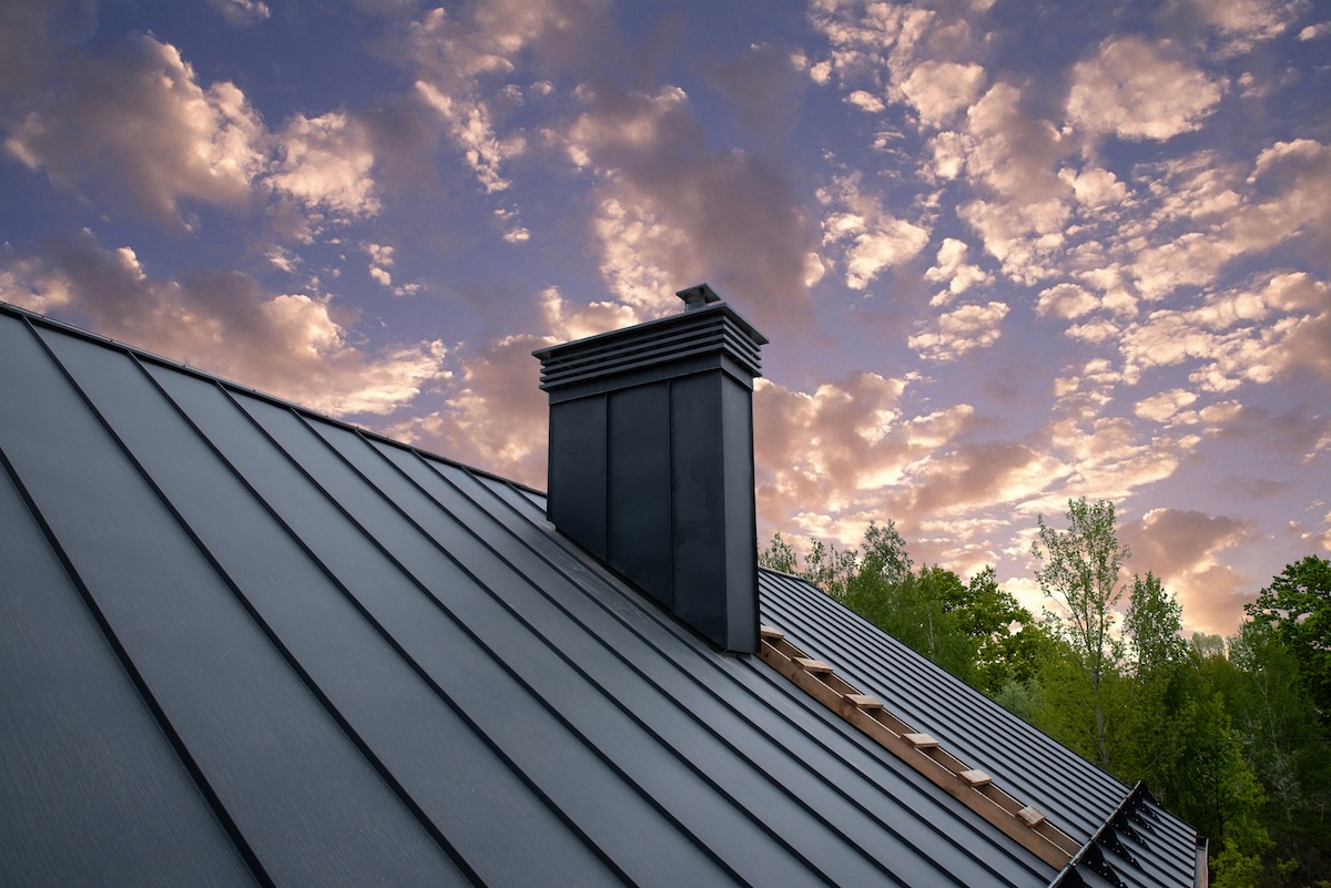 Modern metal chimney on the roof for ventilation types of metal roofing