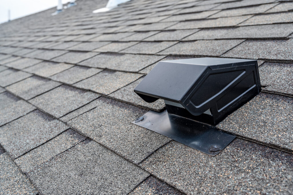 roof vents Roof of commercial building with exhaust vent.