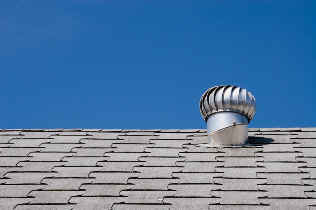 roof vents Roof of commercial building with exhaust vent.
