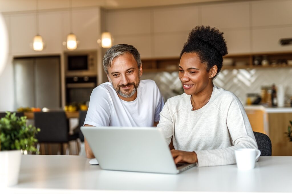 Two adults using modern technology, searching something online.