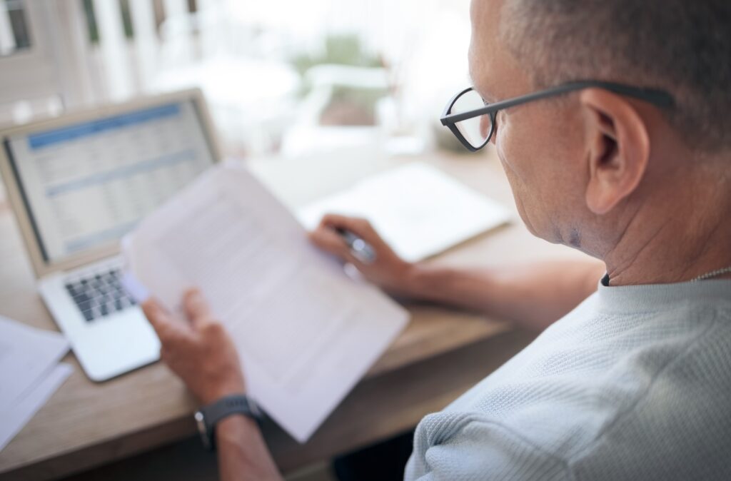 man looking at roofing records