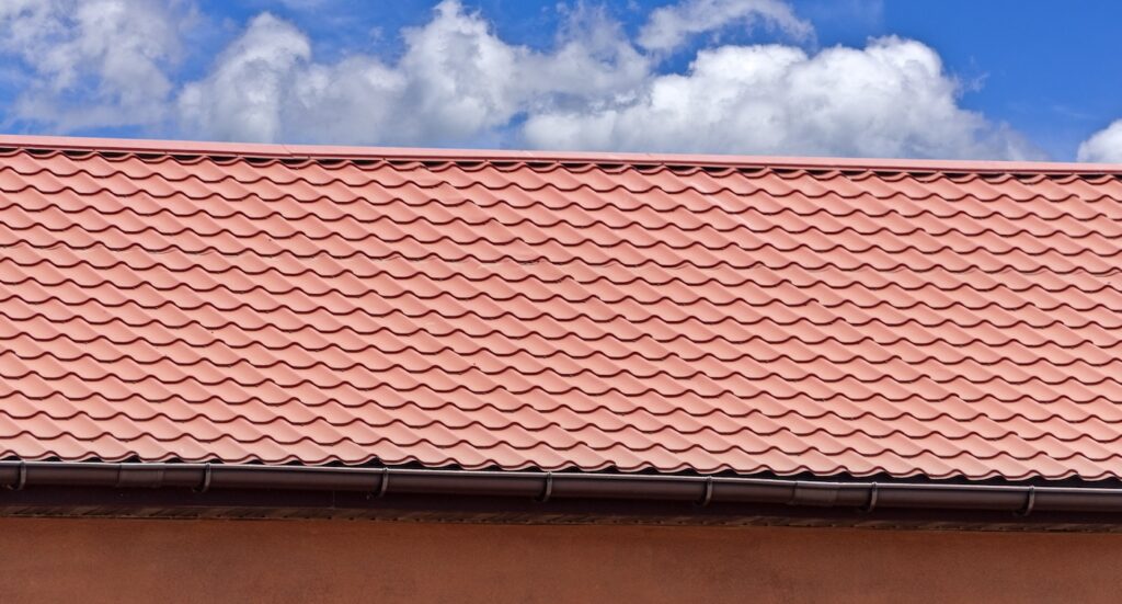 Red metal-tiled building against a blue sky
