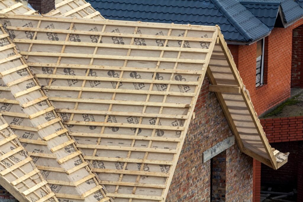 New house roof frame of wooden beams Roofing underlayment, water-resistant waterproof barrier material, protection from severe weather
