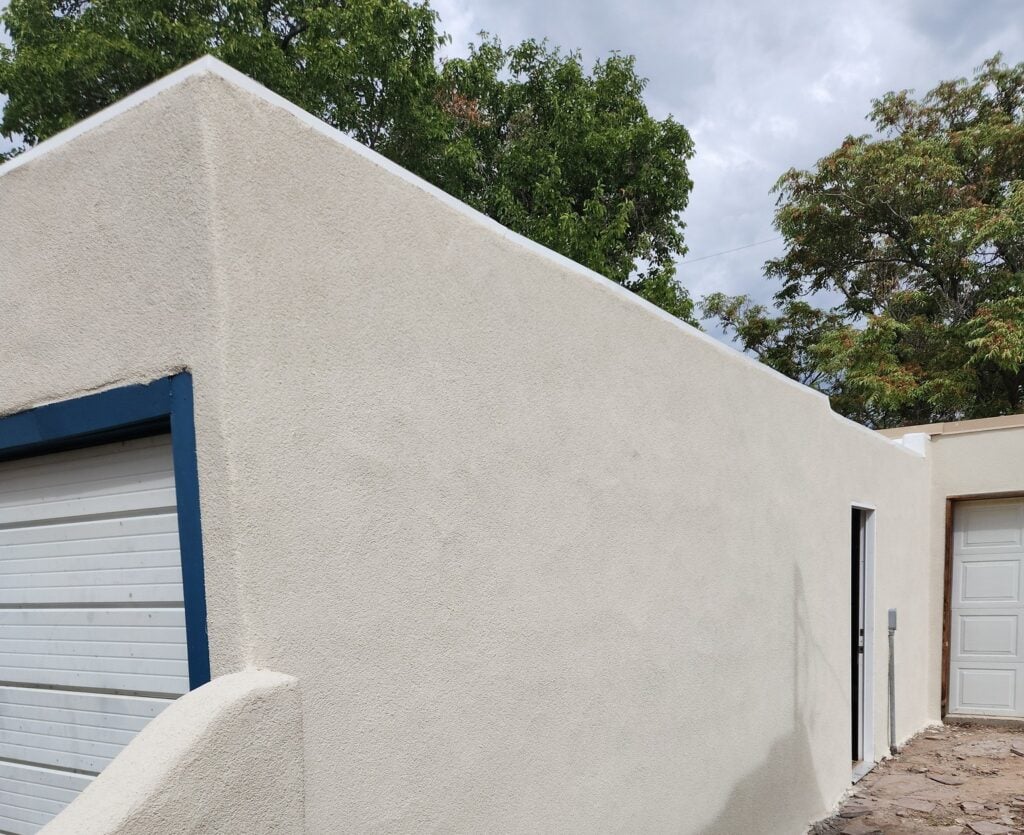 A wall with beige stucco
