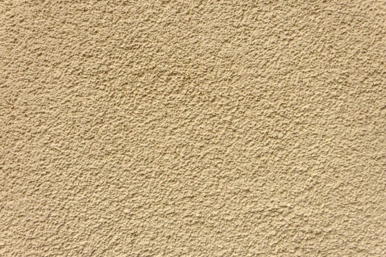 Beige stucco wall with rough texture