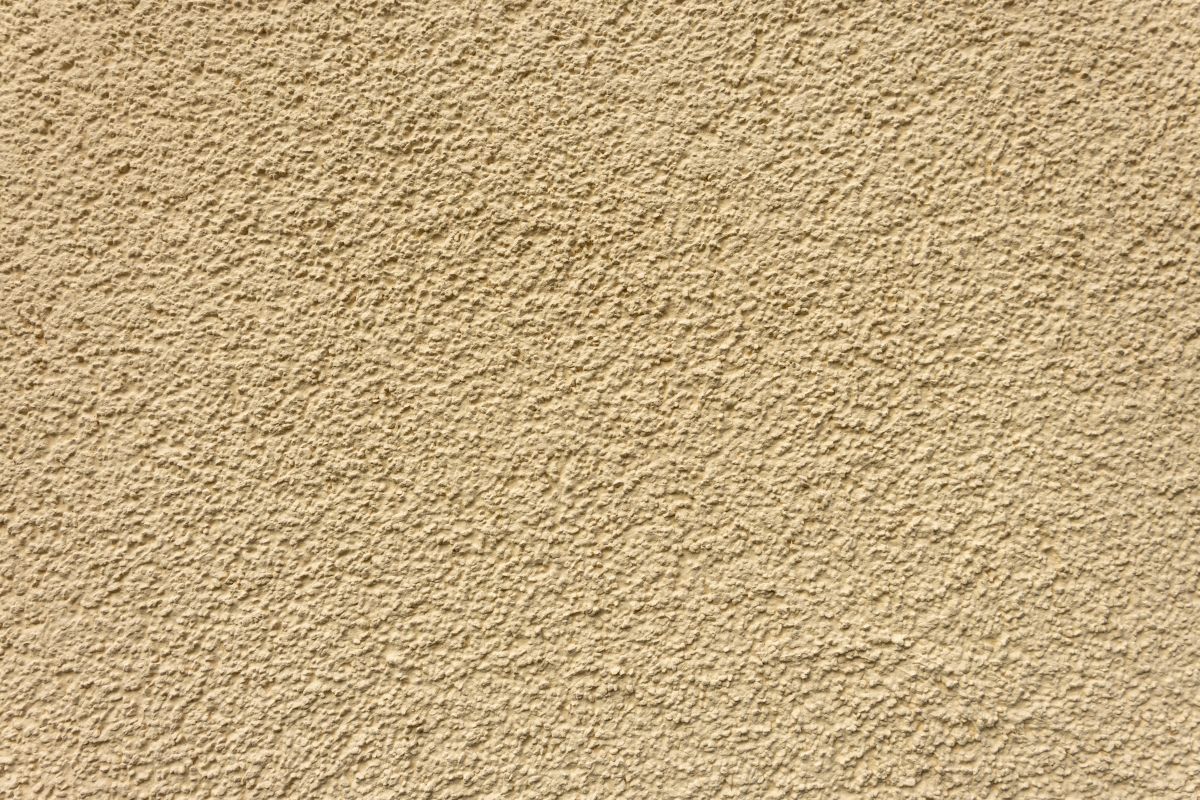 Beige stucco wall with rough texture