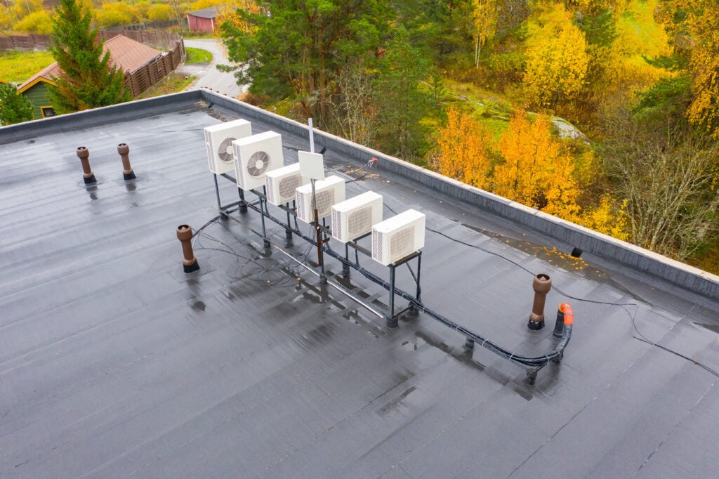 Outdoor air conditioning units on roof. Air conditioning system opens onto roof. Concept - air purification system in building. Flat roof of building top view. Sale oxygen purification equipment.