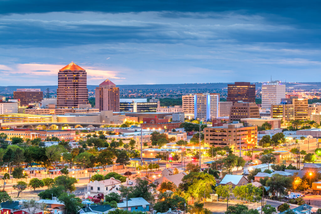 best time of year to replace a roof Albuquerque, New Mexico, USA downtown cityscape at twilight.